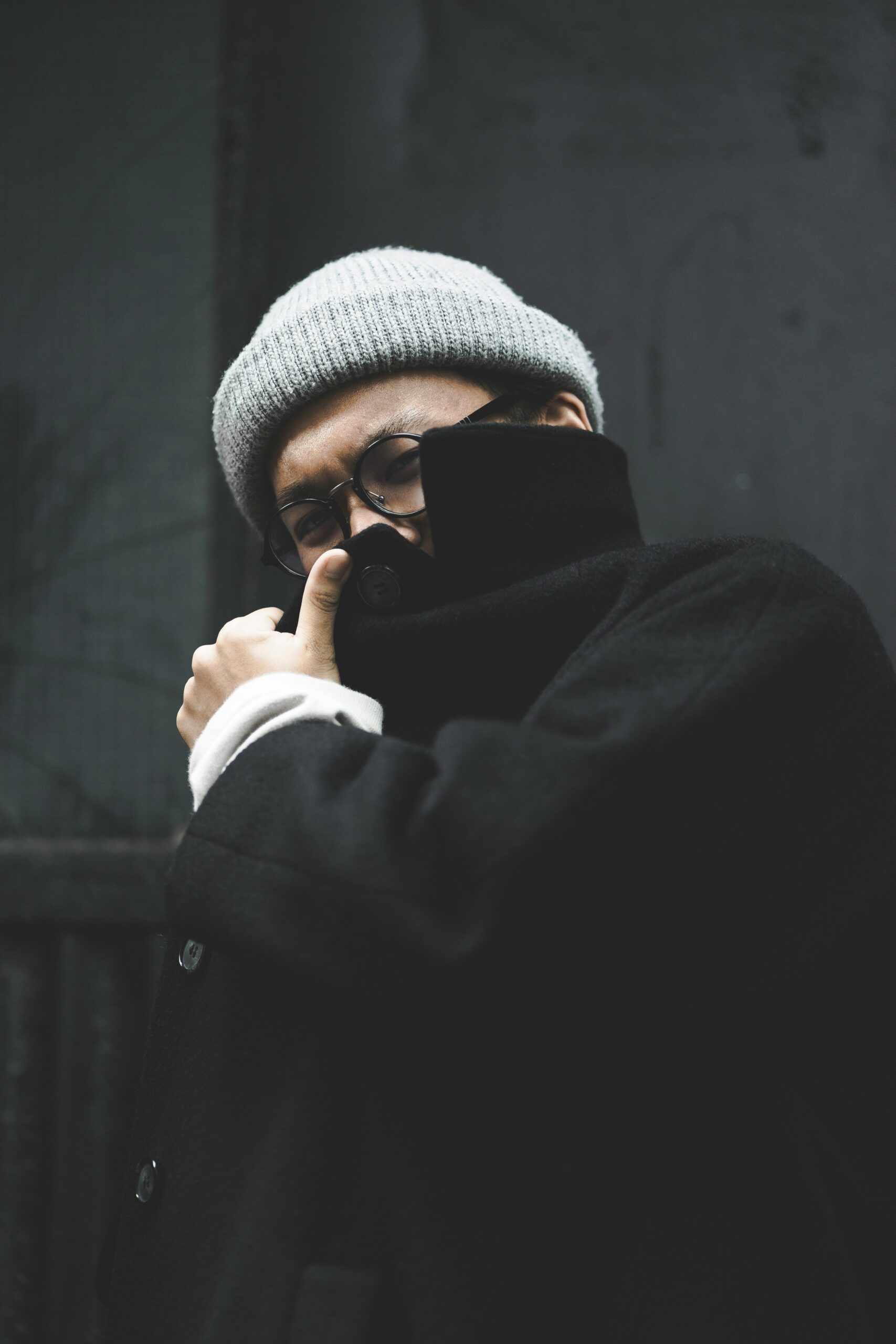 man covering his face with coat